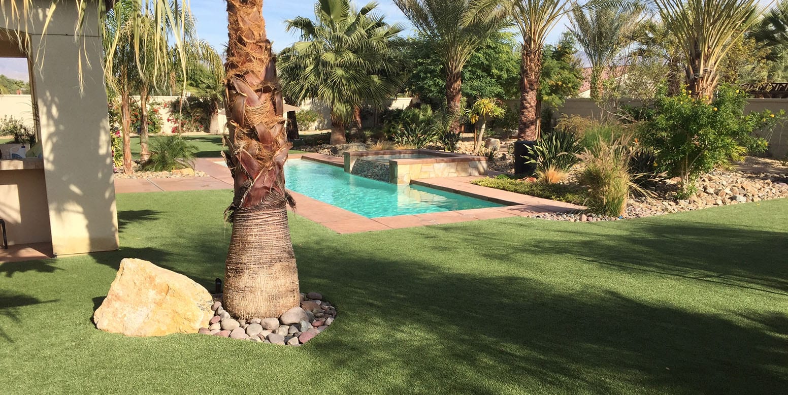 Trees and rocks surrounded by artificial grass